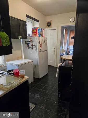 a utility room with cabinets washer and dryer