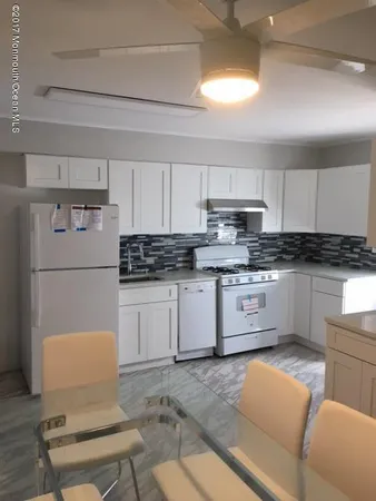 a kitchen with stainless steel appliances granite countertop a refrigerator sink stove microwave and cabinets
