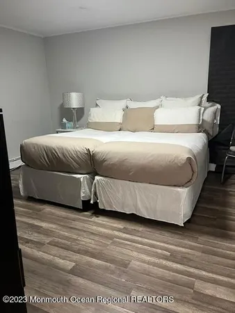 a bedroom with a bed and a night stand