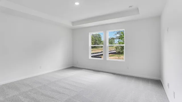 a view of an empty room and a window