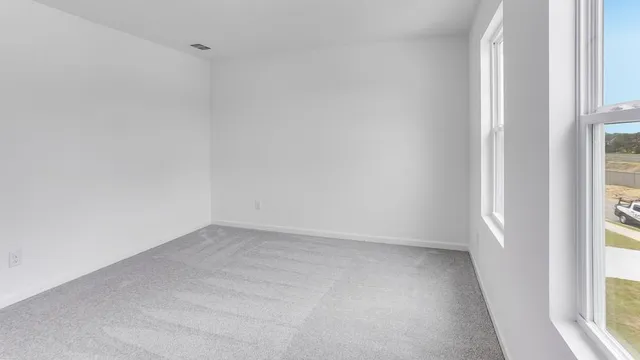 an empty room with windows and wall painting