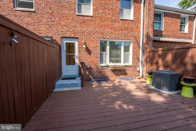 a backyard of a house with barbeque oven and outdoor seating