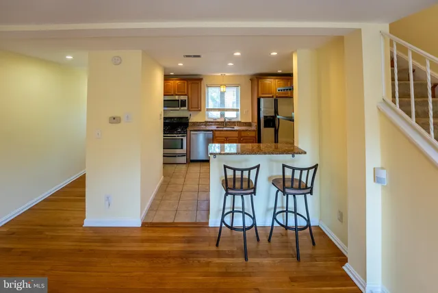 a dining room with furniture and wooden floor