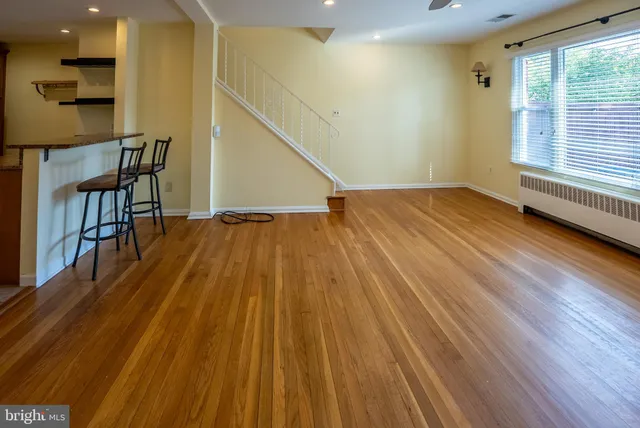 a view of a room with wooden floor and stairs