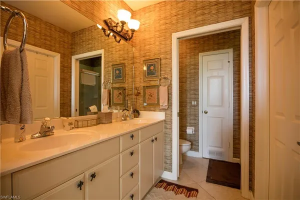 a bathroom with a double vanity sink a mirror and a shower