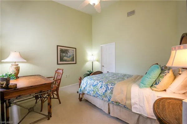 a bedroom with a bed and a table in it