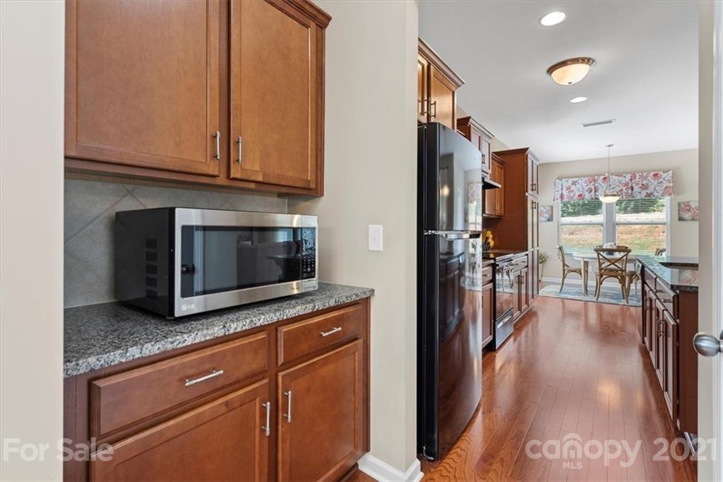 8098 Bryson Road Indian Land, SC 29707 - Photo 13 of 30 a kitchen with stainless steel appliances granite countertop a stove a sink and a microwave