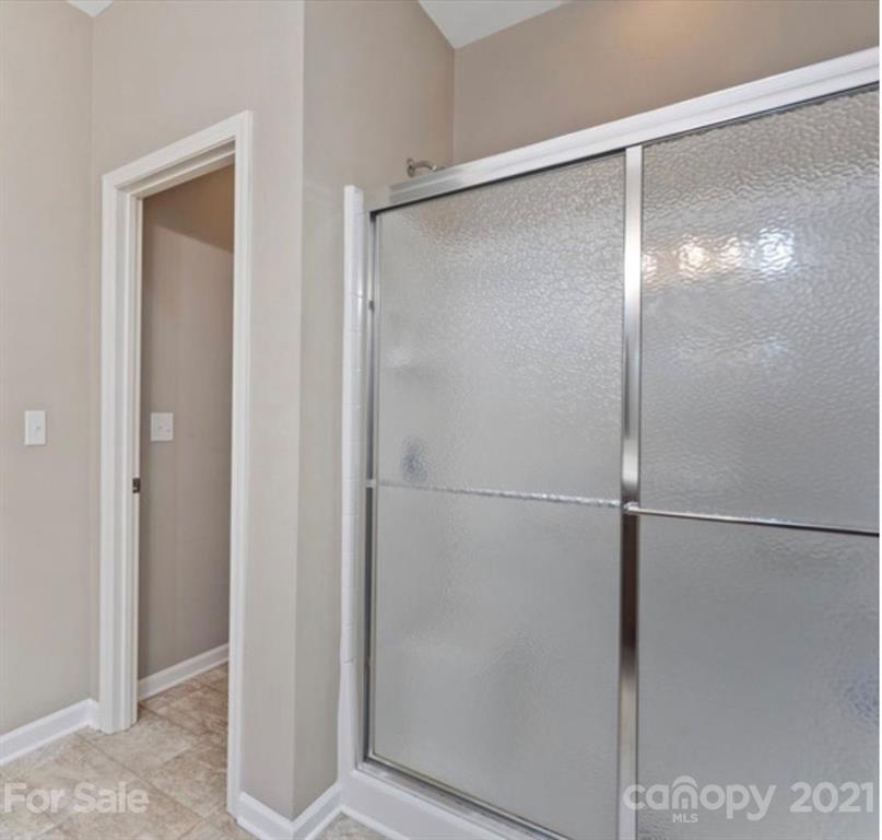8098 Bryson Road Indian Land, SC 29707 - Photo 18 of 30 a bathroom with a glass shower door