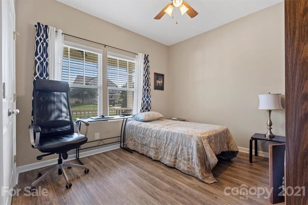 8098 Bryson Road Indian Land, SC 29707 - Photo 19 of 30 a bedroom with a bed and a chandelier