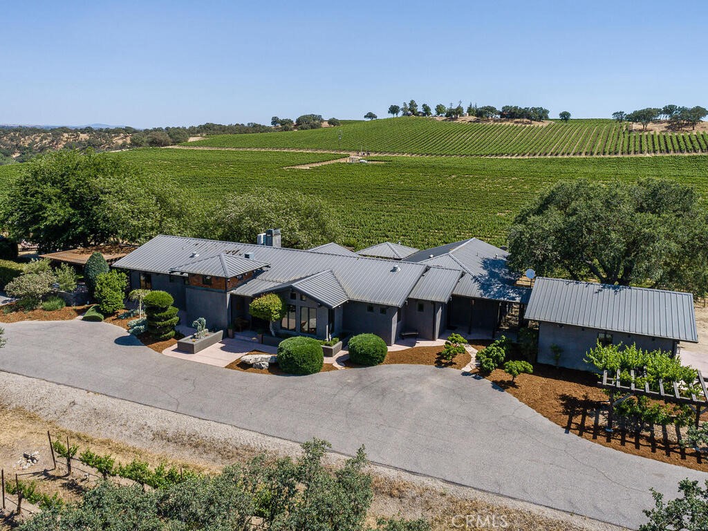 an aerial view of a house with garden space and street view