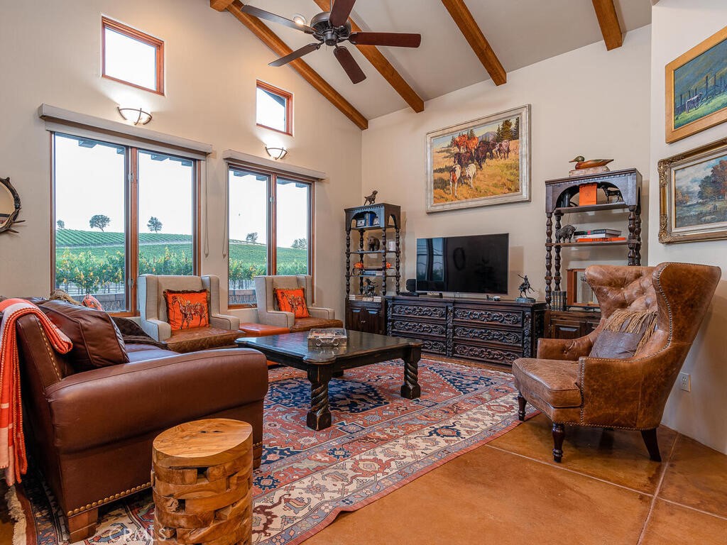 7790 Airport Road Paso Robles, CA 93446 - Photo 11 of 71 a living room with furniture a flat screen tv and a fireplace
