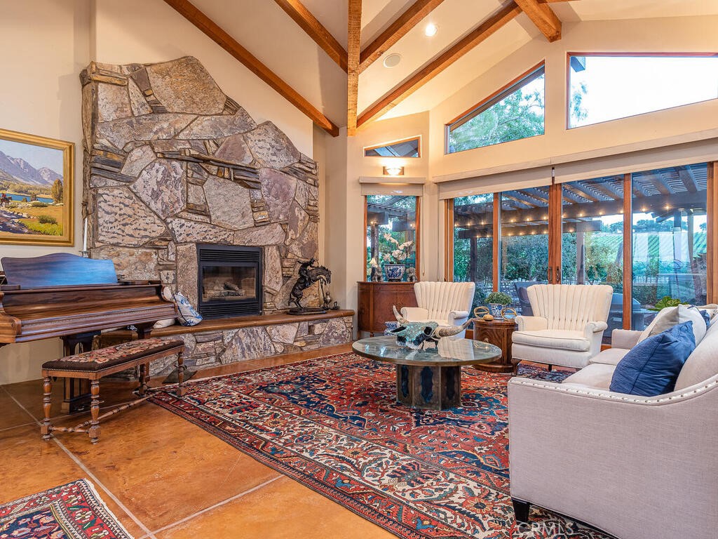 7790 Airport Road Paso Robles, CA 93446 - Photo 4 of 71 a living room with furniture a fireplace and a floor to ceiling window