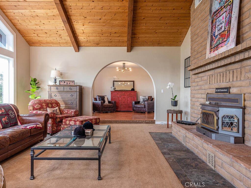 7790 Airport Road Paso Robles, CA 93446 - Photo 46 of 71 a living room with furniture a fireplace and a table