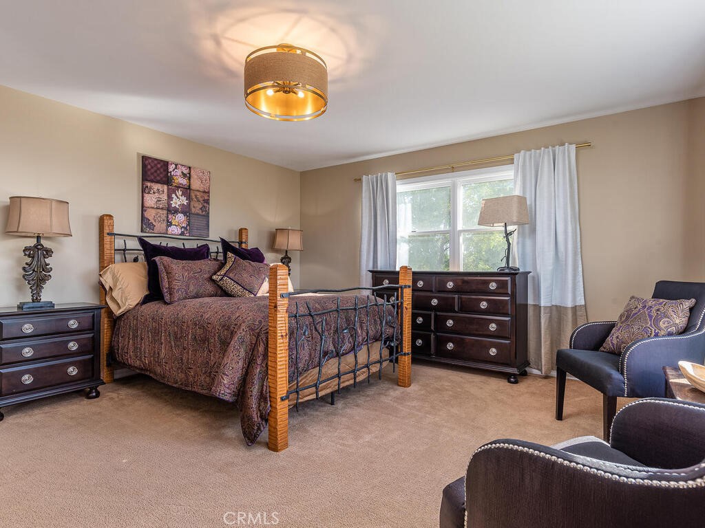 7790 Airport Road Paso Robles, CA 93446 - Photo 51 of 71 a bedroom with a bed and dresser with mirror
