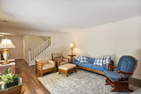 a living room with furniture and a lamp