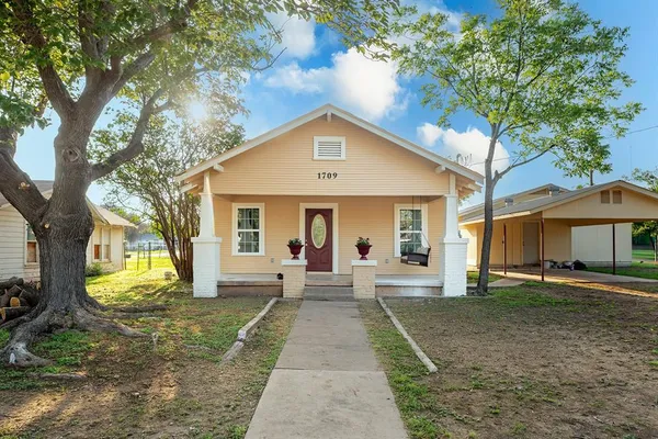a front view of a house with garden