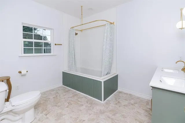 a bathroom with a sink toilet and shower