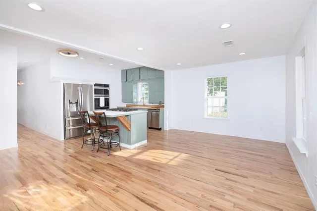 a view of a kitchen with a dining table chairs and entryway