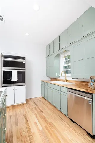 a kitchen with stainless steel appliances kitchen island granite countertop a sink and cabinets