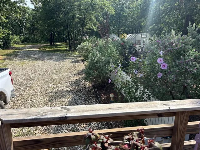 a view of backyard with wooden floor and outdoor seating