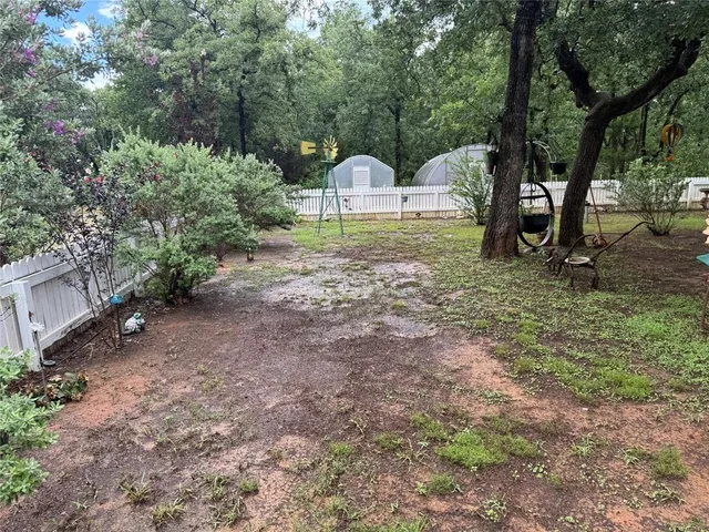 a backyard of a house with table and chairs