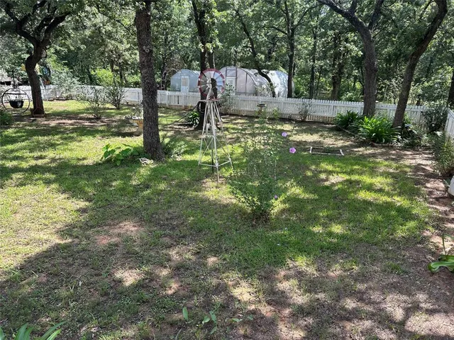a backyard of a house with fountain table and chairs