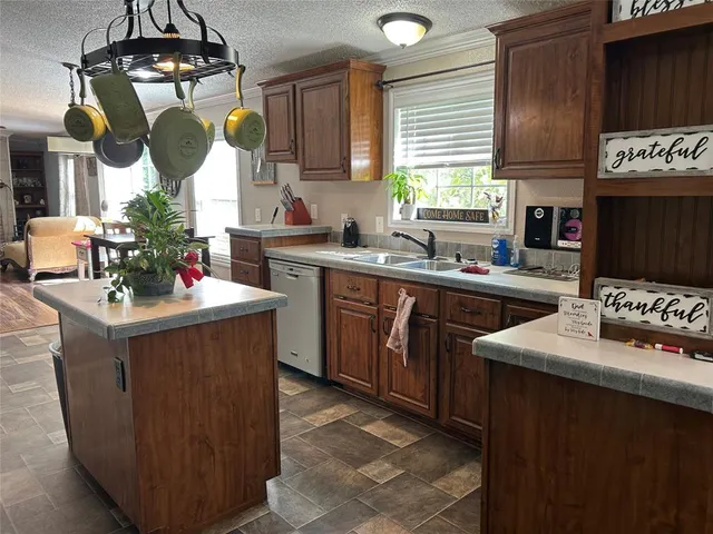 a kitchen with a sink stove and cabinets