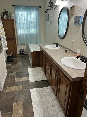 a bathroom with a double vanity sink and a mirror