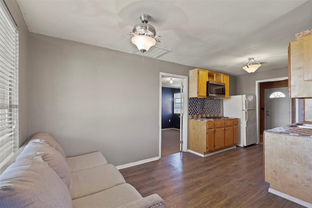 1556 John Wayne Road Kaufman, TX 75142 - Photo 23 of 33 a living room with furniture and a chandelier