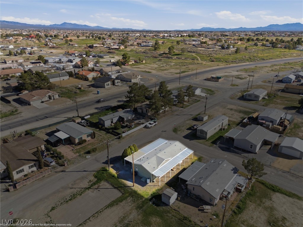 20 Rudy Road Pahrump, NV 89048 - Photo 29 of 32 Aerial view captures the residence set against a backdrop of rolling hills and distant mountains.
