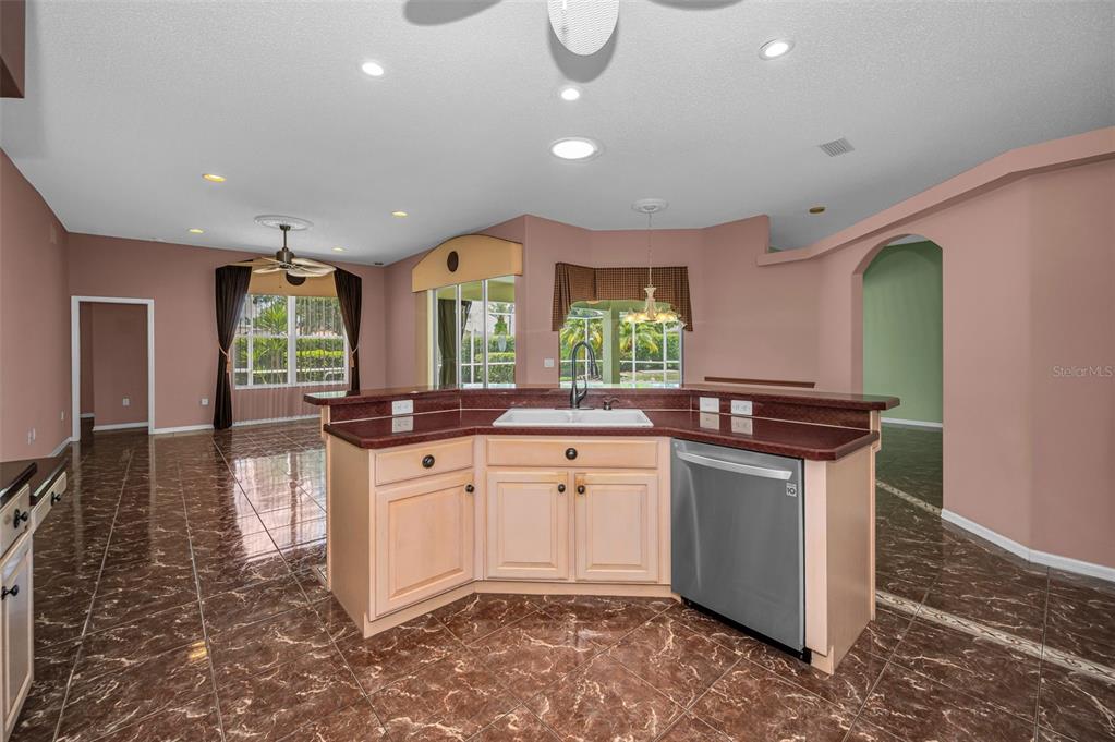 11917 Hadleigh Way Trinity, FL 34655 - Photo 16 of 84 a kitchen with stainless steel appliances granite countertop a sink a stove and a wooden floors