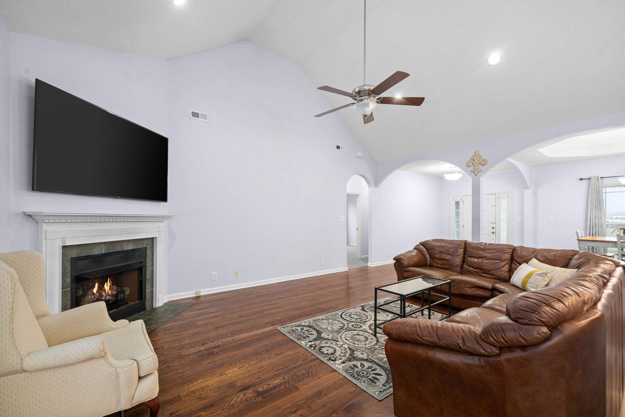 233 Barkers Mill Road Pembroke, KY 42266 - Photo 14 of 48 a living room with furniture a fireplace and a flat screen tv