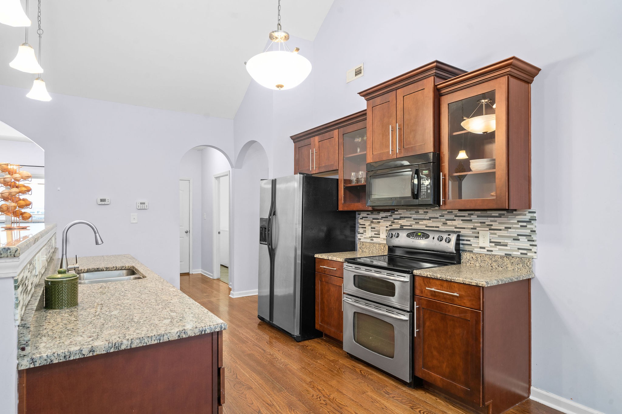 233 Barkers Mill Road Pembroke, KY 42266 - Photo 20 of 48 a kitchen with stainless steel appliances granite countertop a stove a sink and a refrigerator