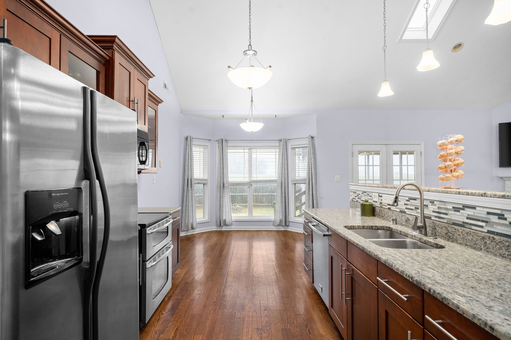 233 Barkers Mill Road Pembroke, KY 42266 - Photo 22 of 48 a kitchen with stainless steel appliances granite countertop a refrigerator a sink dishwasher a stove and white countertops with wooden floor
