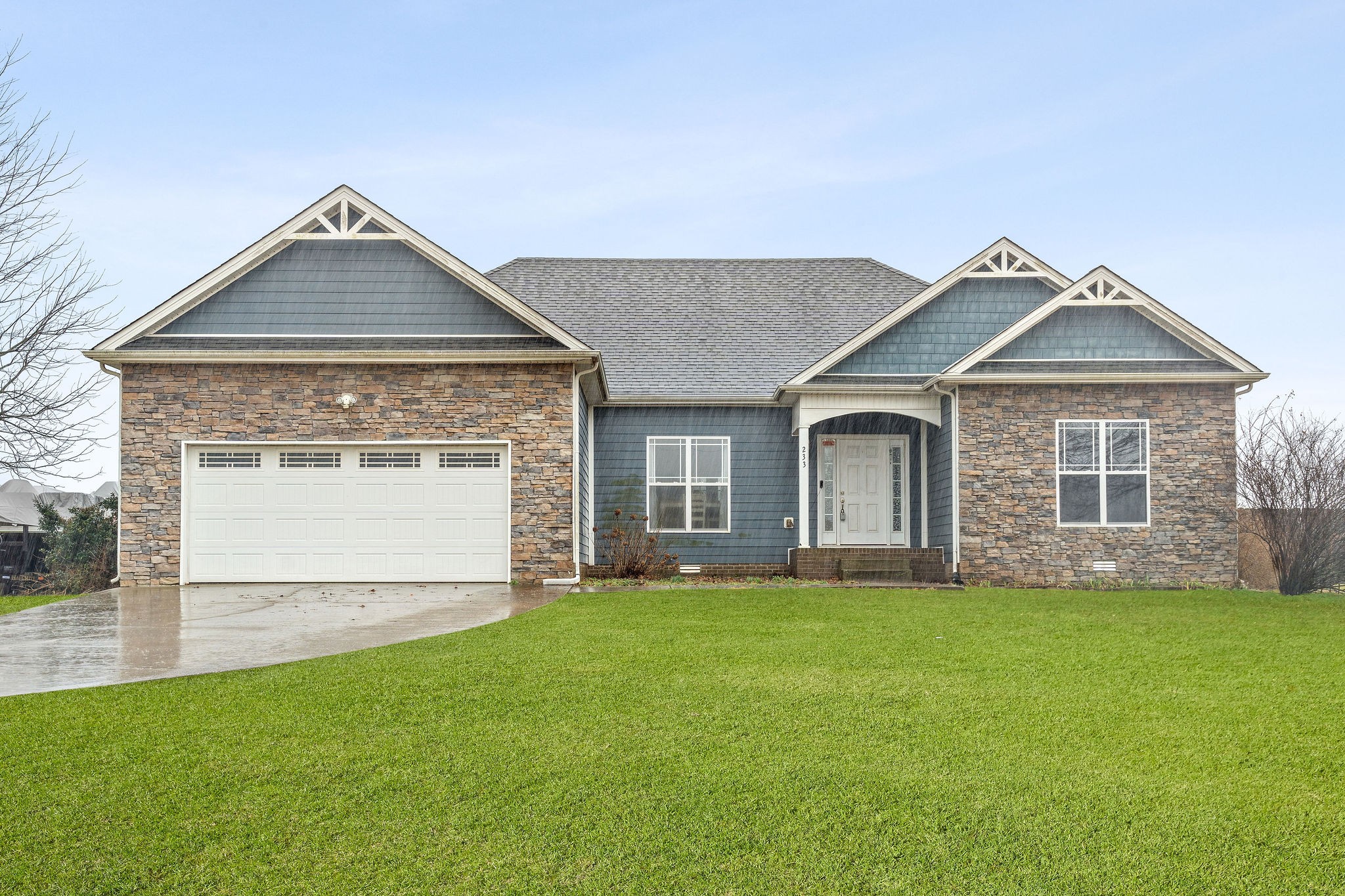 233 Barkers Mill Road Pembroke, KY 42266 - Photo 3 of 48 a front view of a house with a yard and garage