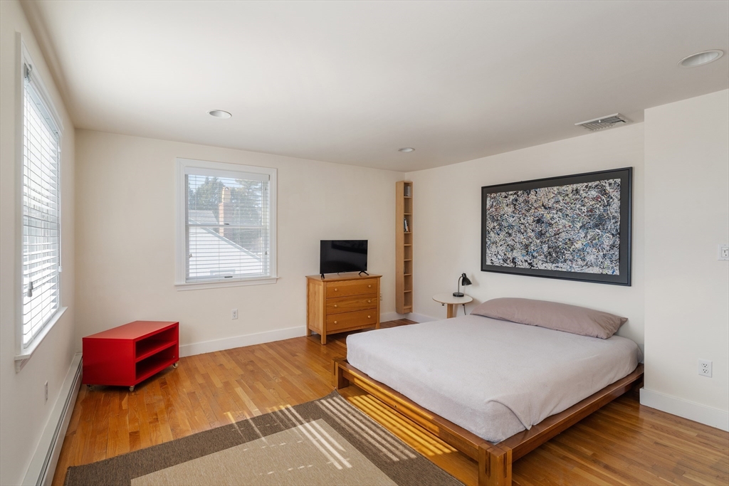 10 Redstone Lane Marblehead, MA 01945 - Photo 20 of 31 a bedroom with a bed and wooden floor