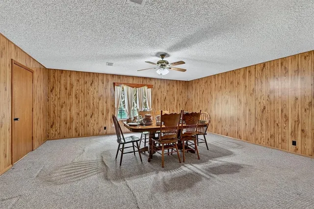 a view of a dining room with furniture and a chandelier