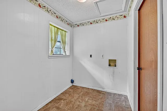 a view of a big room with wooden floor and windows