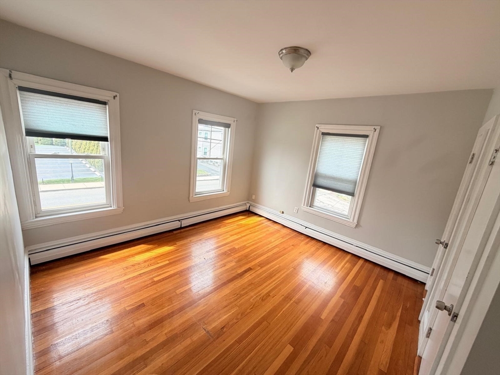 465 High Street, Unit 2 Dedham, MA 02026 - Photo 8 of 12 a view of empty room with wooden floor and fan