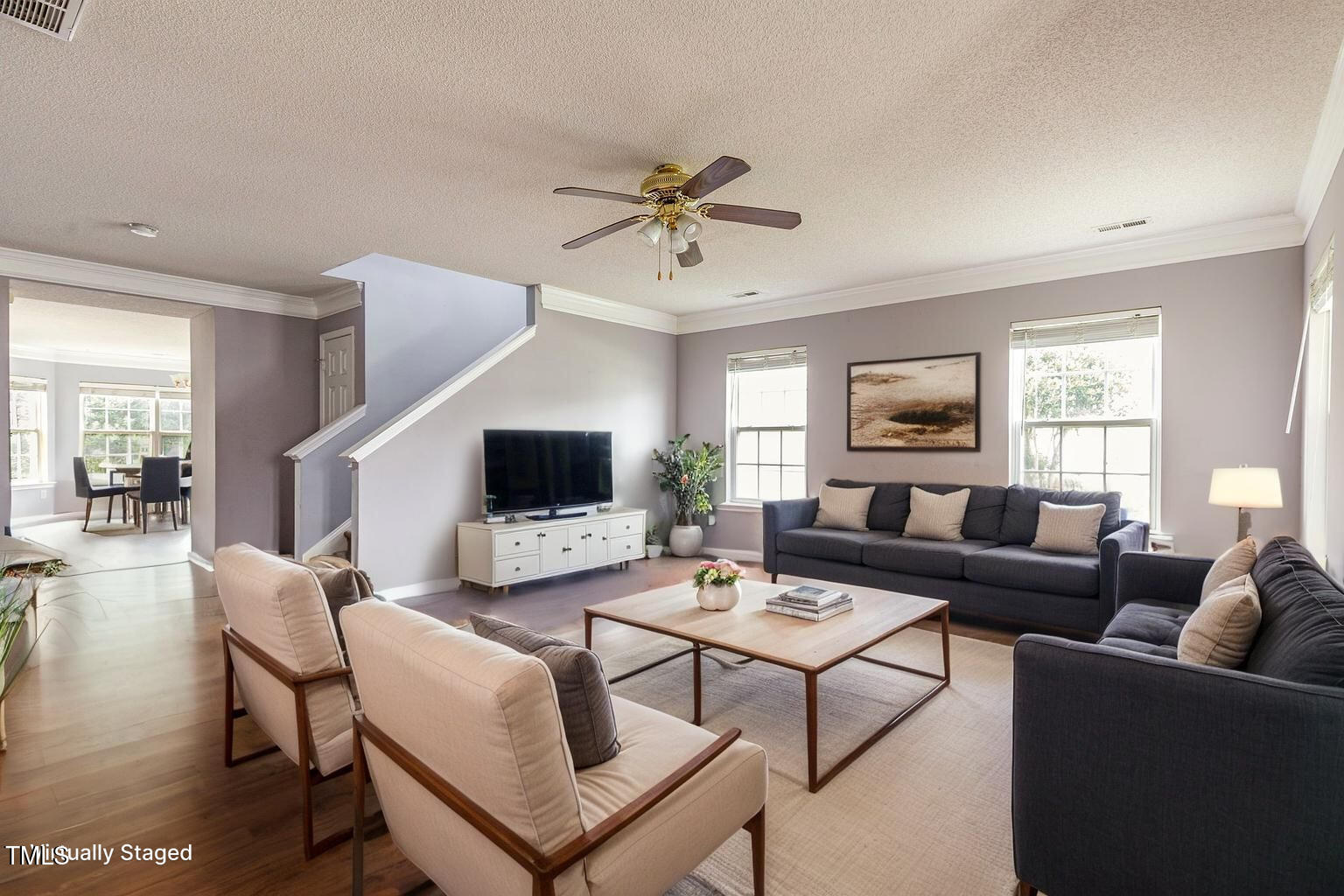 2640 Quarry Springs Road Raleigh, NC 27610 - Photo 1 of 31 a living room with furniture a ceiling fan a rug and a window