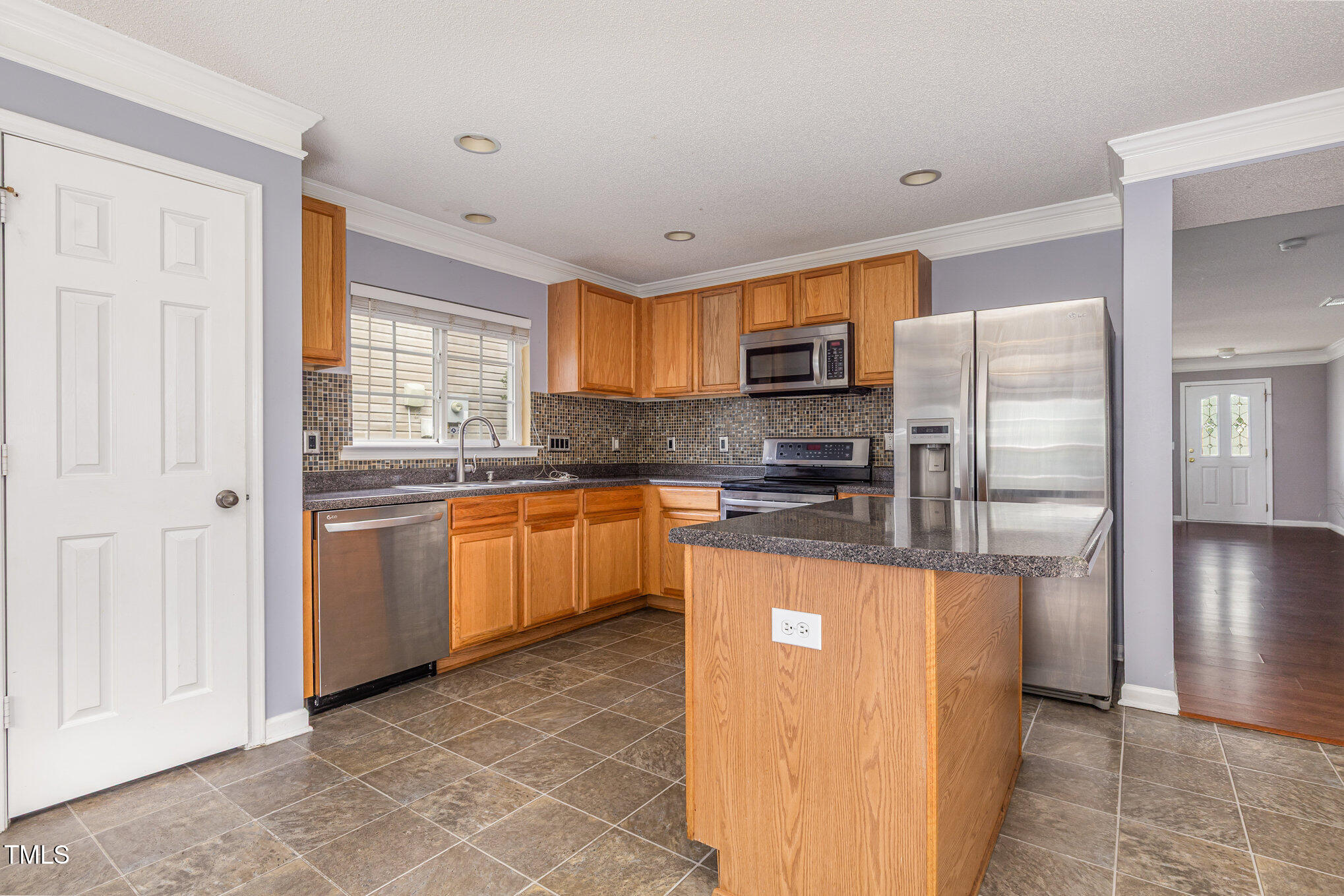 2640 Quarry Springs Road Raleigh, NC 27610 - Photo 7 of 31 a kitchen with stainless steel appliances granite countertop a refrigerator a stove top oven a sink and dishwasher