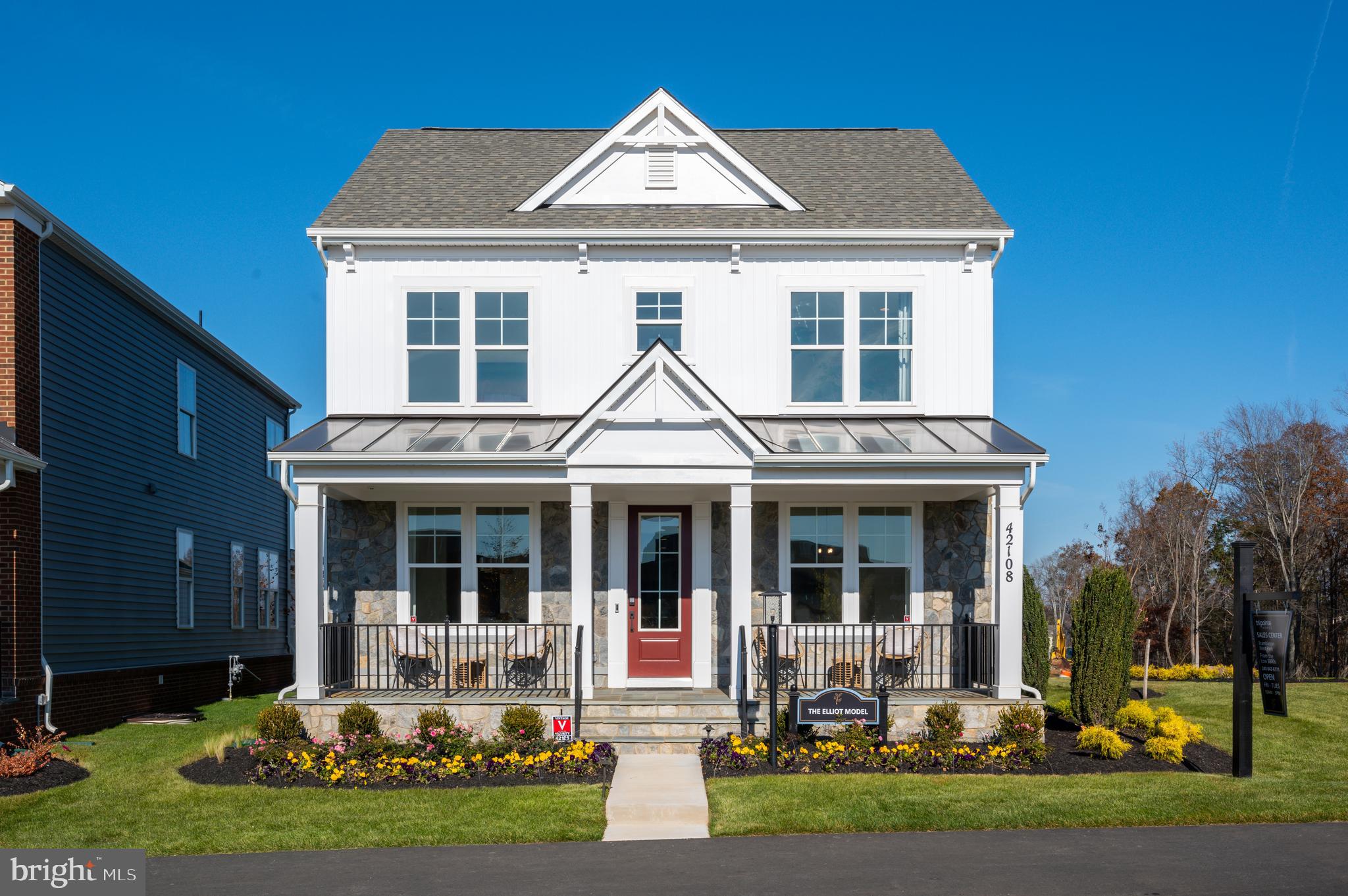 42108 Creighton Road Ashburn, VA 20148 - Photo 1 of 39 a front view of a house with garden and porch