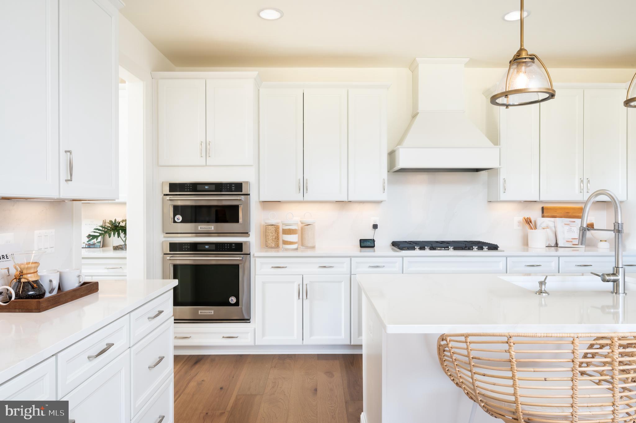 42108 Creighton Road Ashburn, VA 20148 - Photo 11 of 39 a kitchen with stainless steel appliances granite countertop a sink stove oven and white cabinets