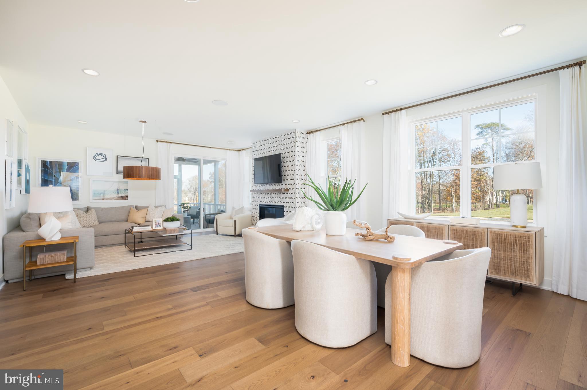 42108 Creighton Road Ashburn, VA 20148 - Photo 16 of 39 a living room with furniture a wooden floor and a large window