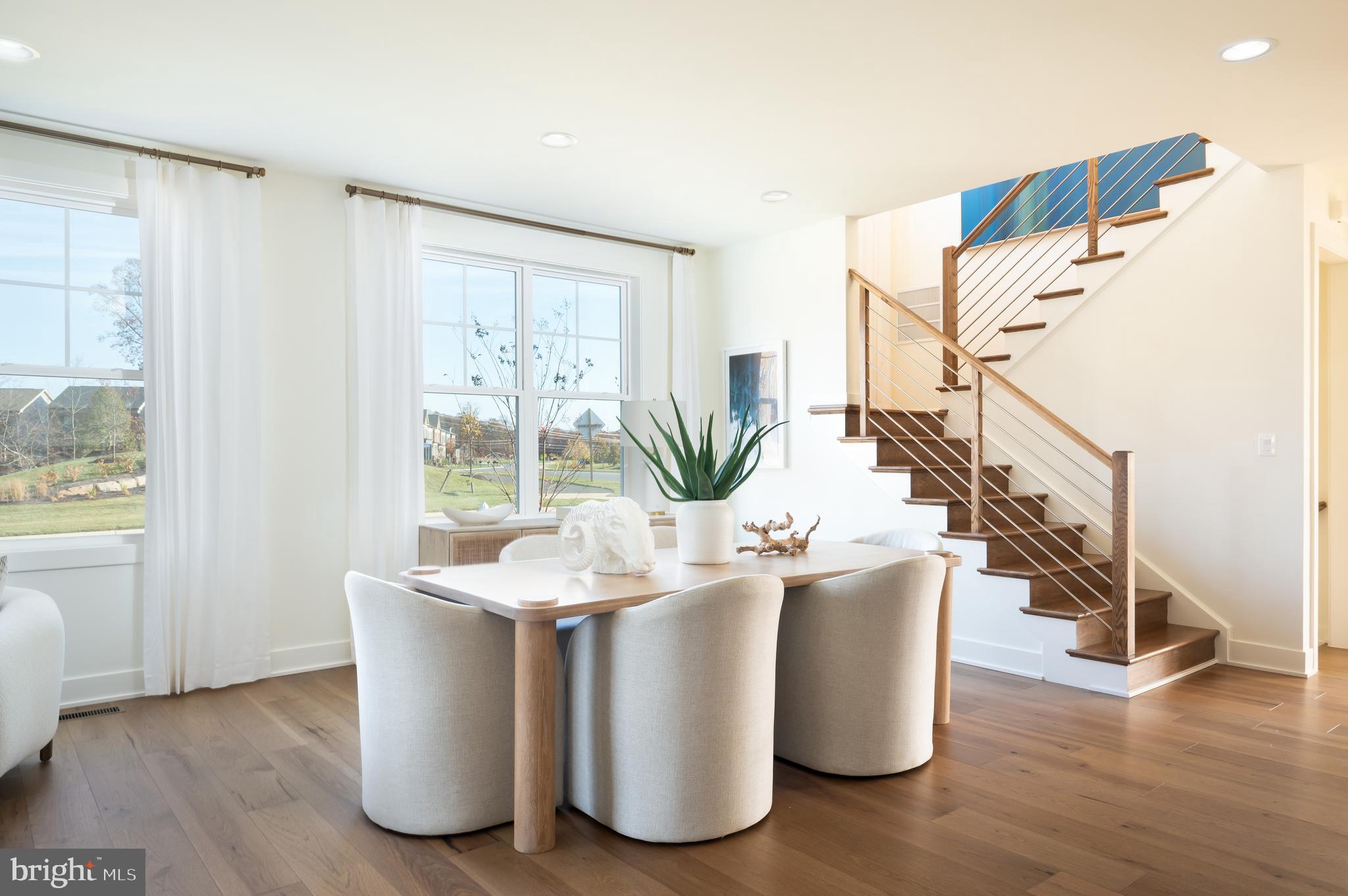 42108 Creighton Road Ashburn, VA 20148 - Photo 17 of 39 a dining room with wooden floor and a chandelier