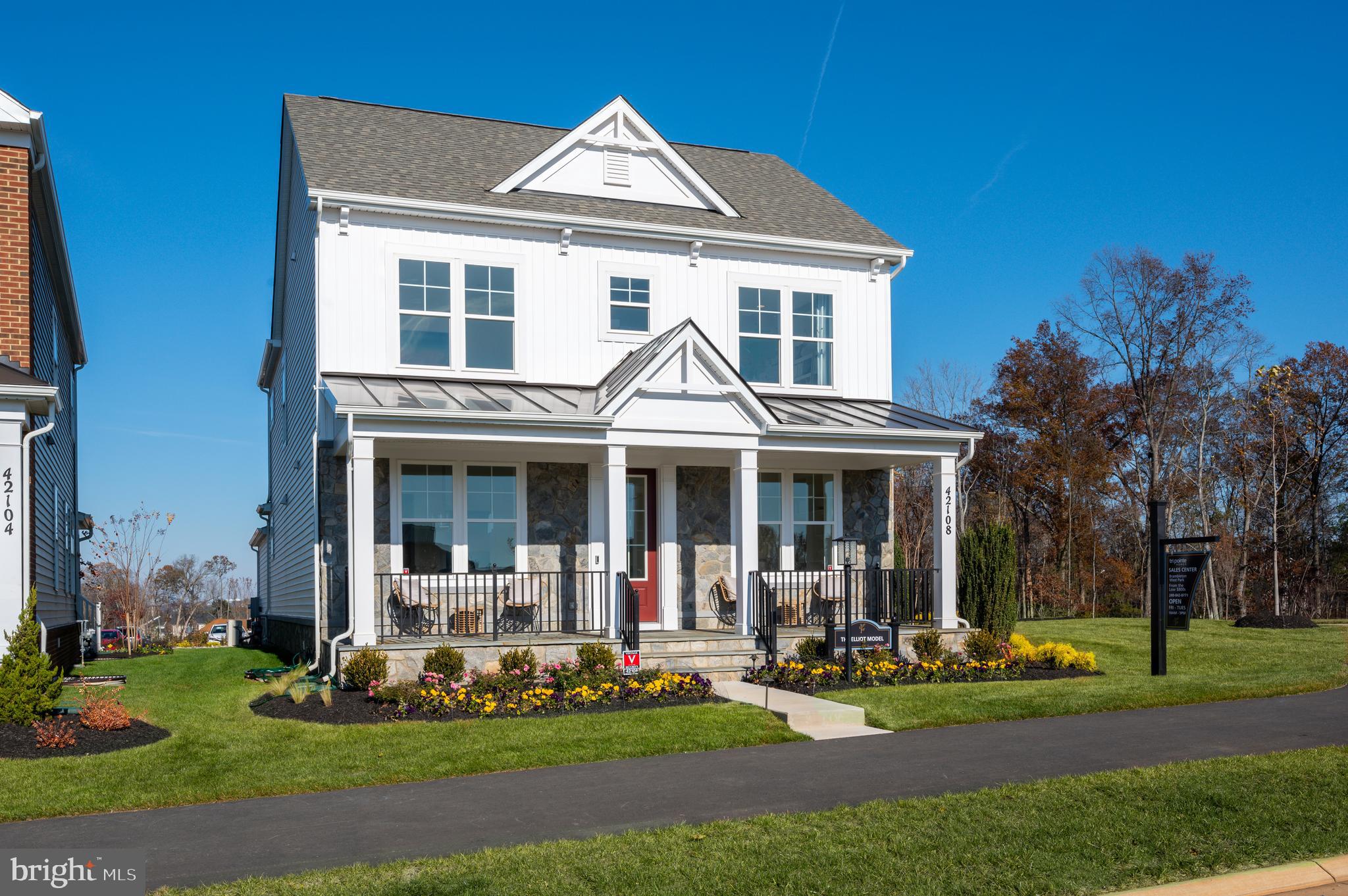 42108 Creighton Road Ashburn, VA 20148 - Photo 2 of 39 a front view of a house with garden and trees