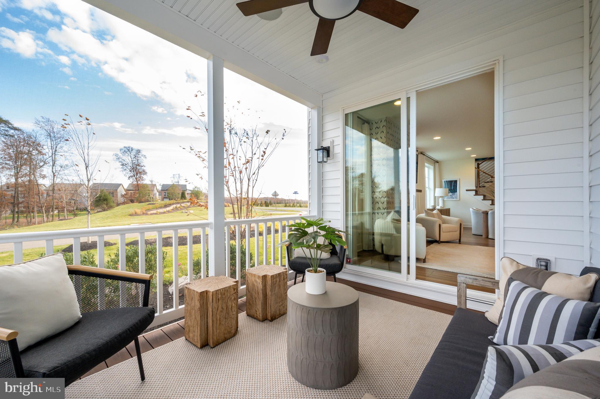 42108 Creighton Road Ashburn, VA 20148 - Photo 21 of 39 a living room with furniture and a floor to ceiling window