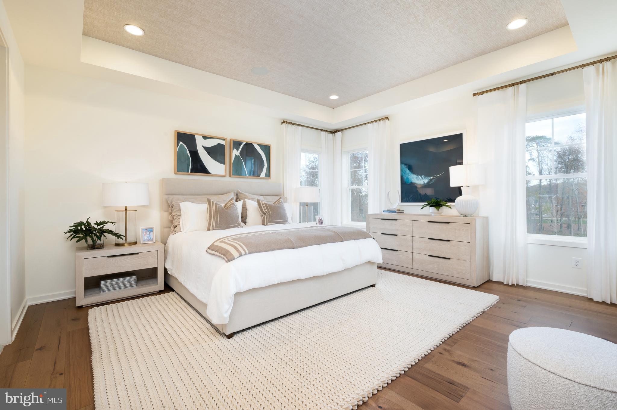 42108 Creighton Road Ashburn, VA 20148 - Photo 22 of 39 a bedroom with a bed and a flat screen television