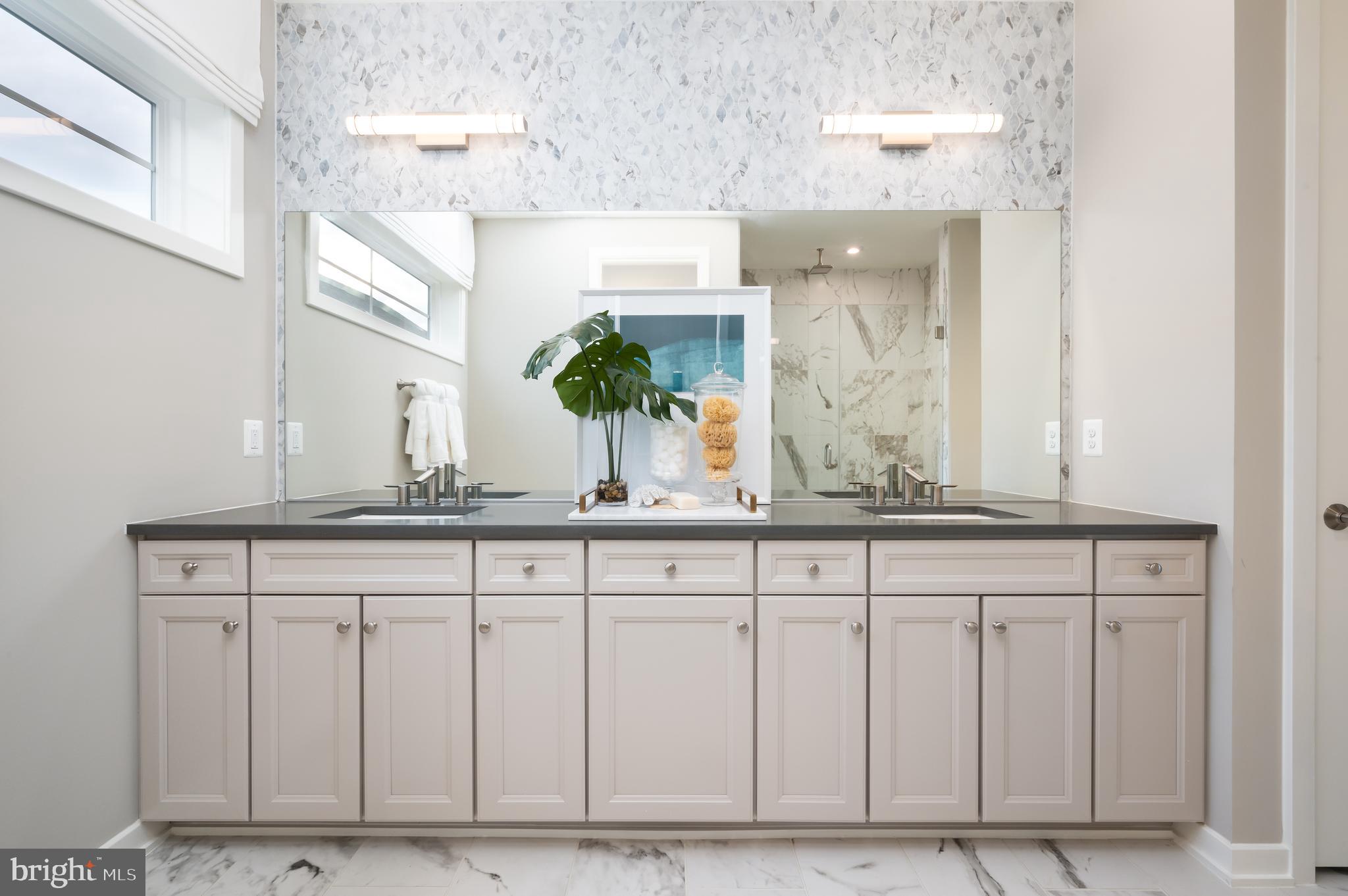 42108 Creighton Road Ashburn, VA 20148 - Photo 27 of 39 a bathroom with a granite countertop sink and a mirror