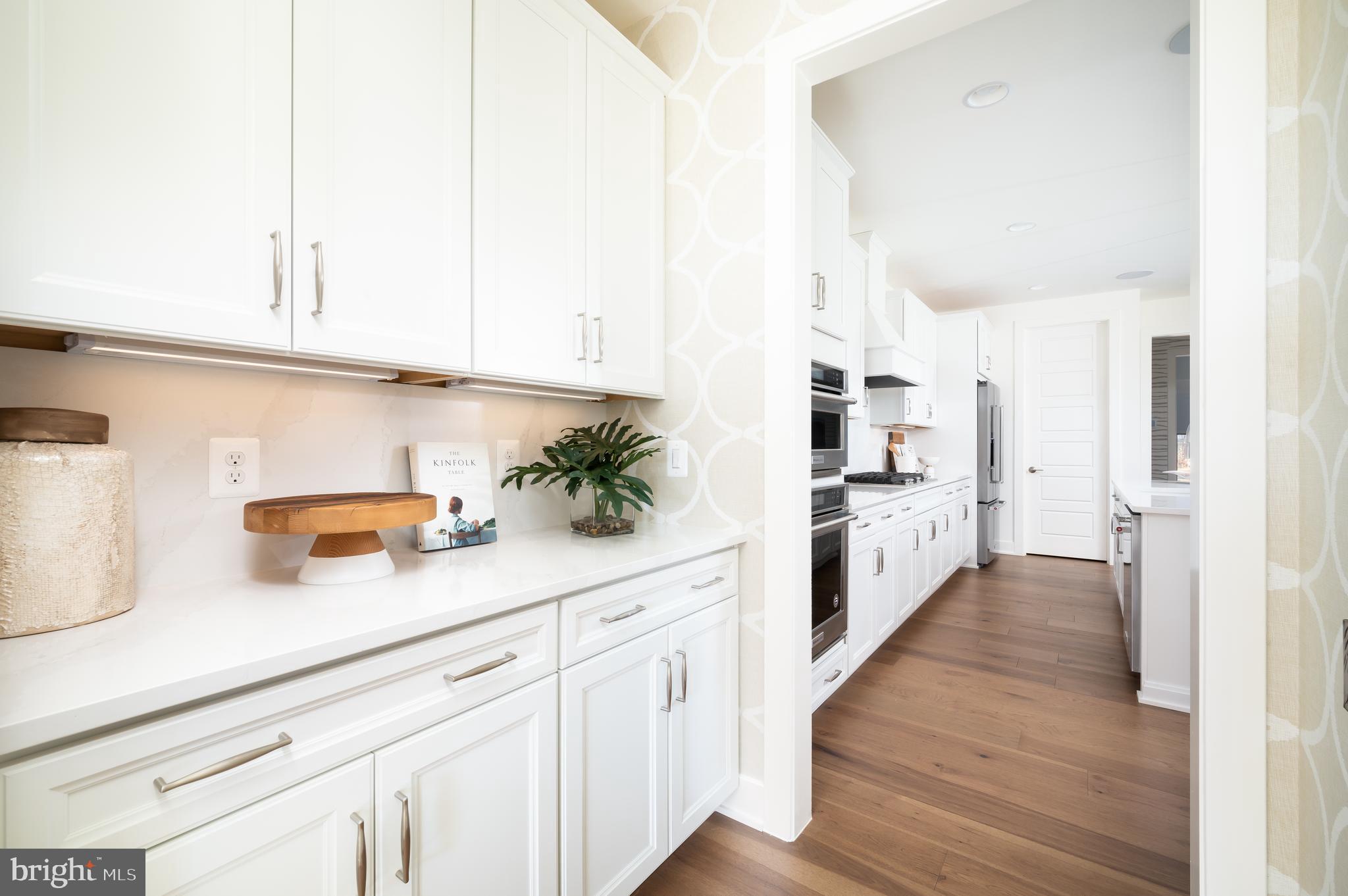 42108 Creighton Road Ashburn, VA 20148 - Photo 8 of 39 a kitchen with stainless steel appliances white cabinets and a refrigerator